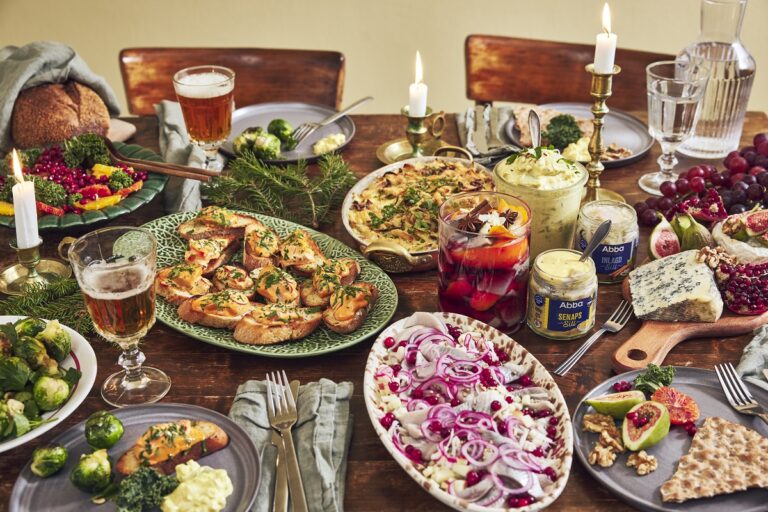 Uppdukat julbord med sillburkar och fat med julskinka, sill knäckebröd.